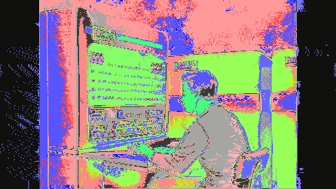 An animated diagram from a 1950s instructional film showing a man at the console of an IBM 704 mainframe